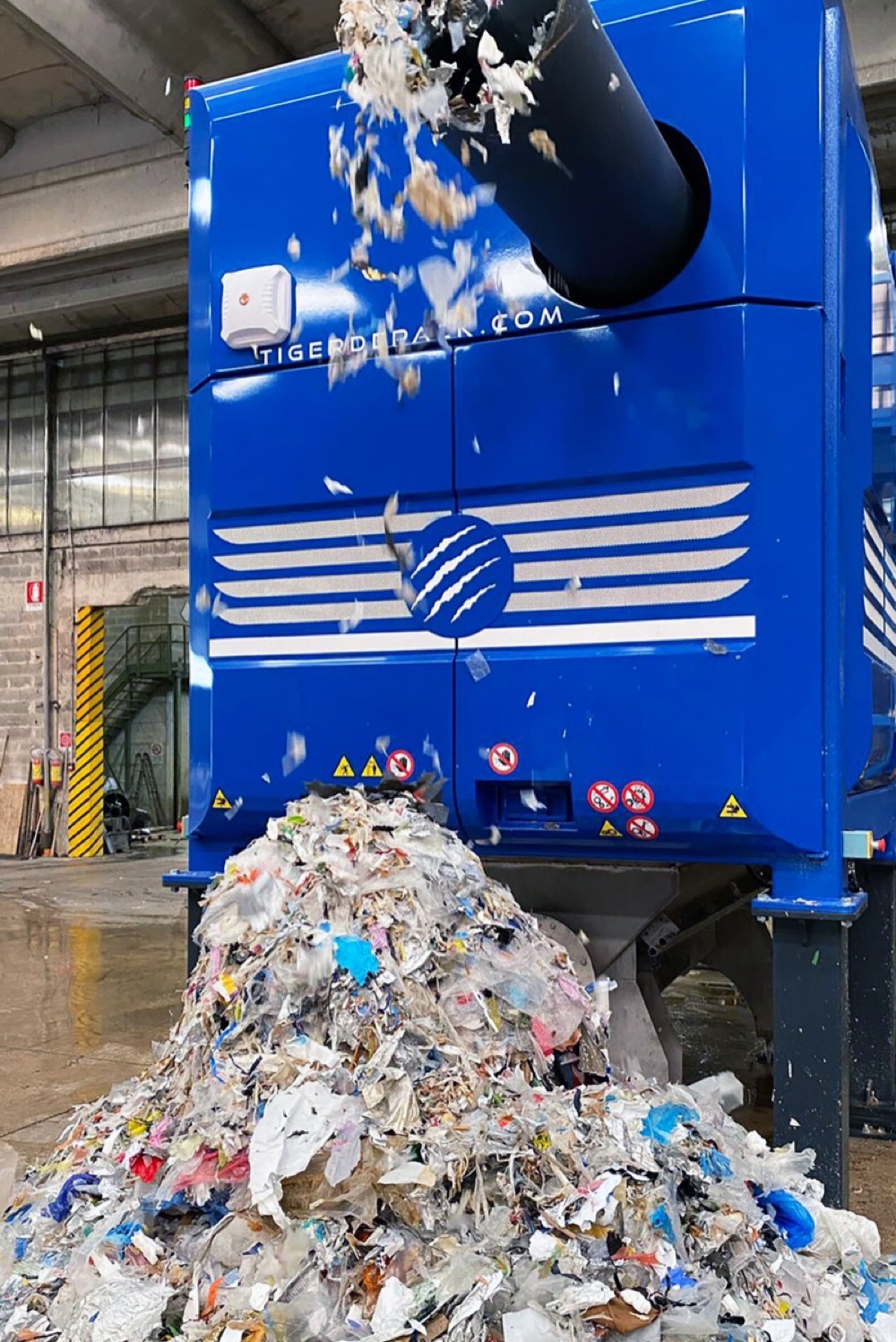 Tiger de-packer machine outputting separated plastic packaging waste