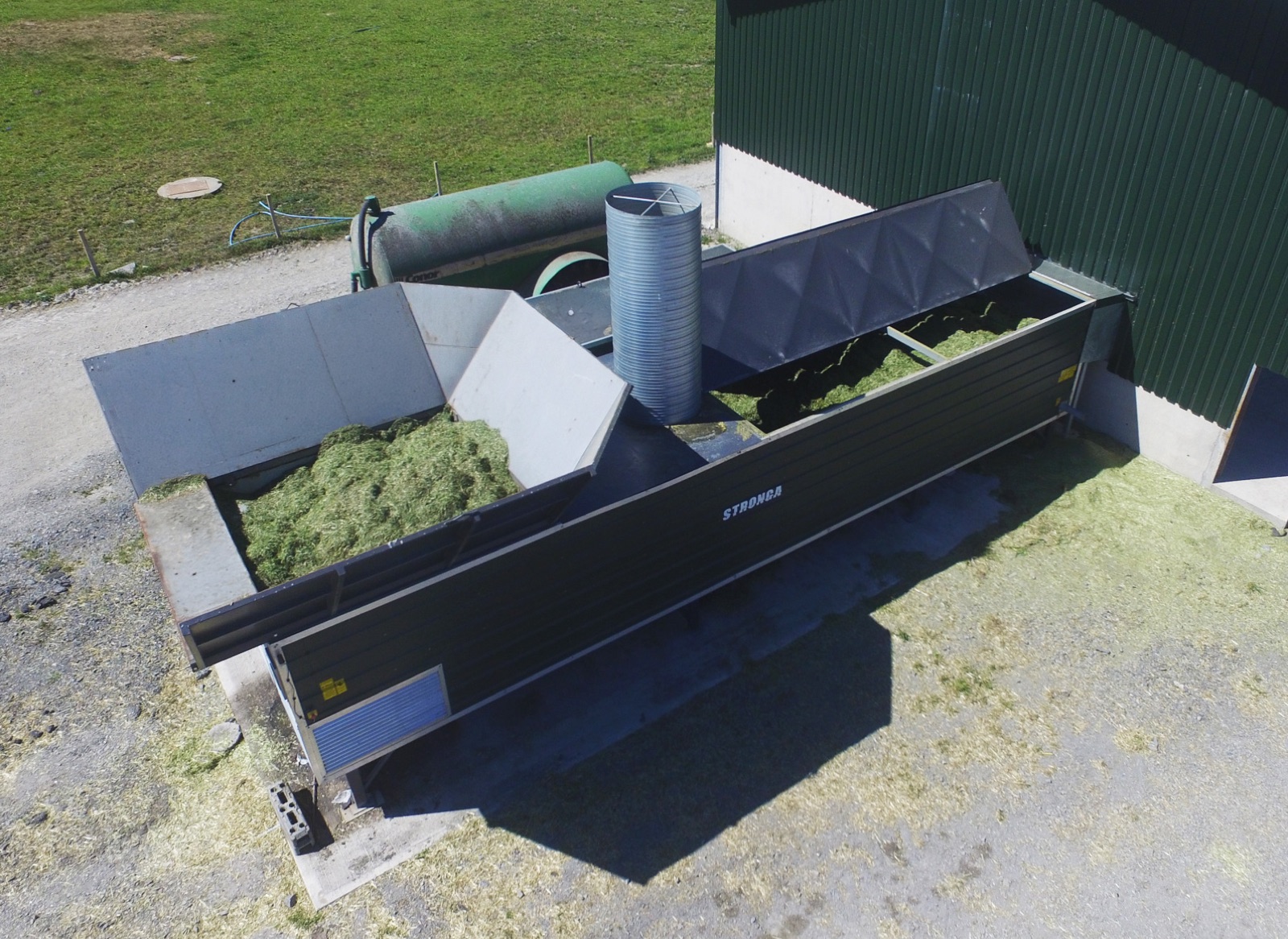 Overhead view of the STRONGA FlowDrya machine drying chopped rye grass forage on-farm