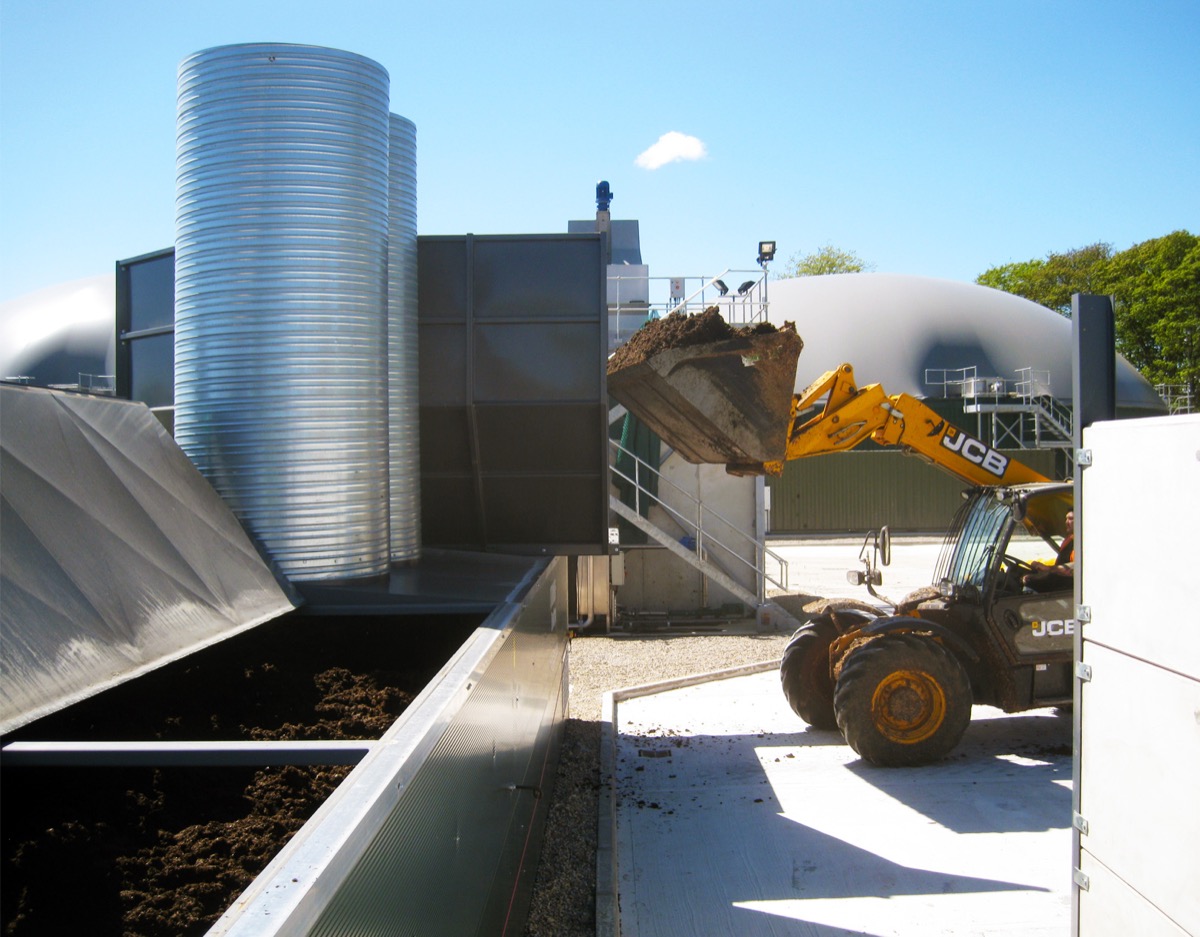JCB loading wet digestate fibre into FlowDrya drying equipment at AD plant